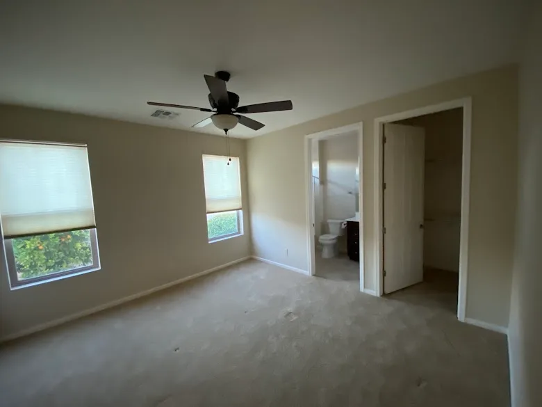 Bedroom with freshly painted walls and ceiling fan