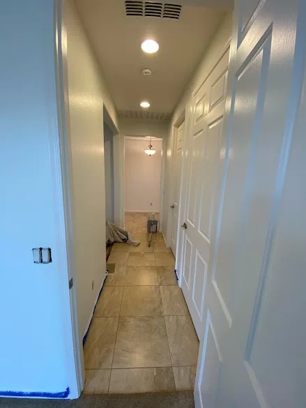 Painted interior doors and trim along a home hallway